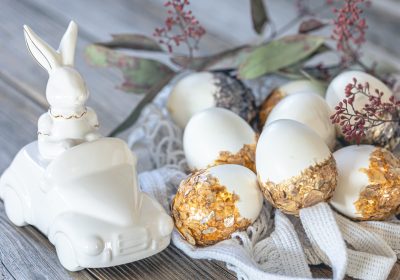 Easter background with festive eggs and decorative ceramic hare. Easter holiday concept.