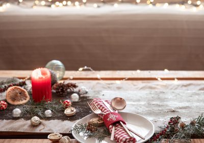 Christmas background with cutlery and a plate on the festive table, copy space.