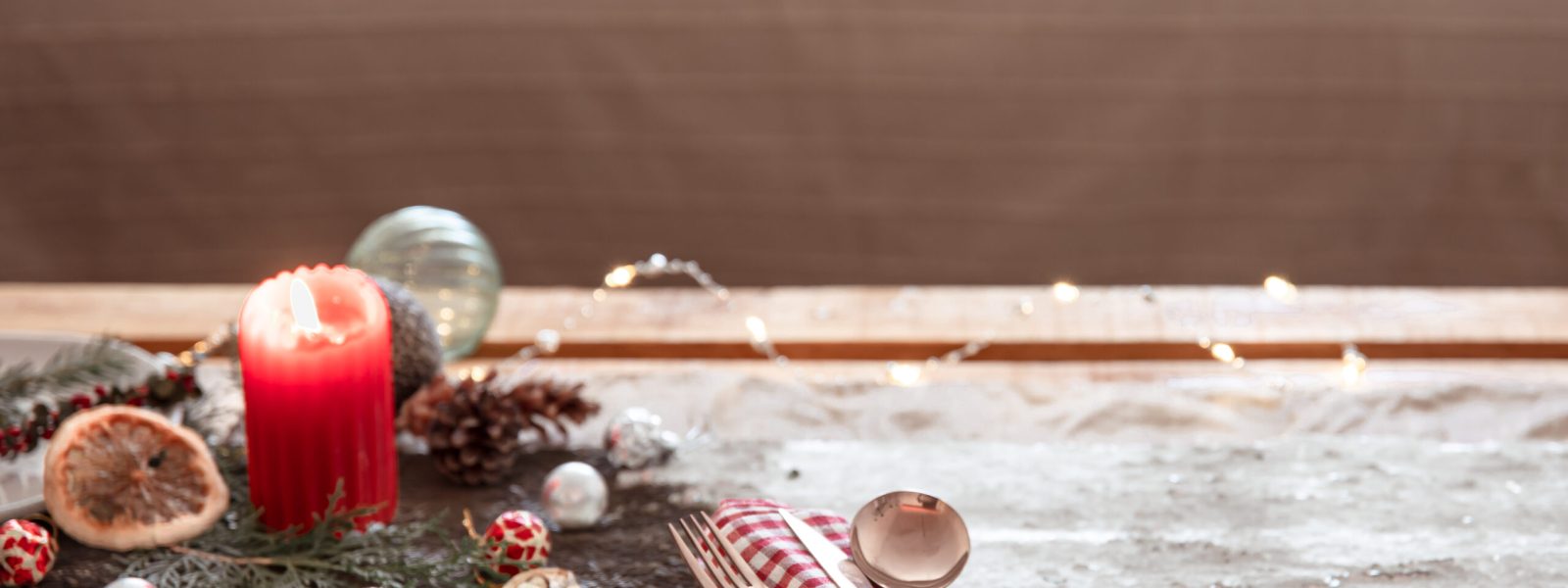 Christmas background with cutlery and a plate on the festive table, copy space.
