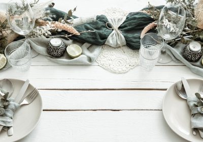 Stylish festive table setting with Scandinavian decor details on a wooden surface.