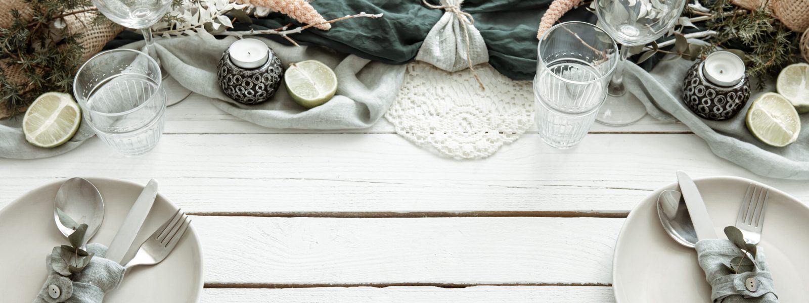 Stylish festive table setting with Scandinavian decor details on a wooden surface.